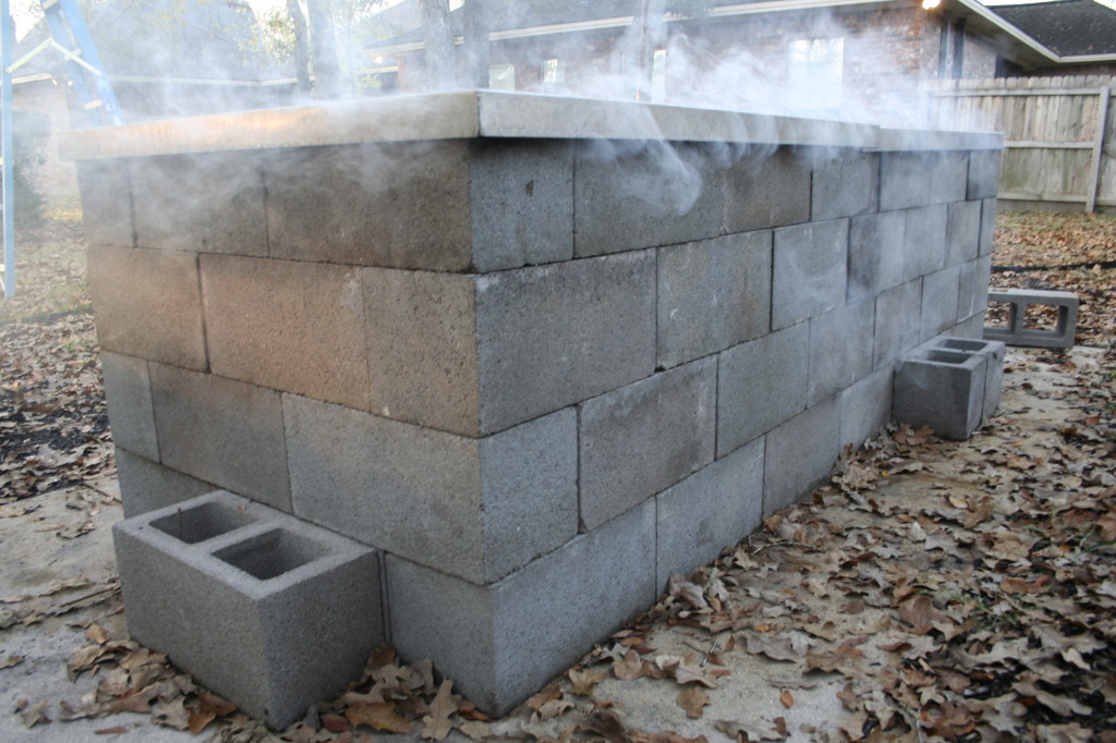 Cinder-block pit smoking away