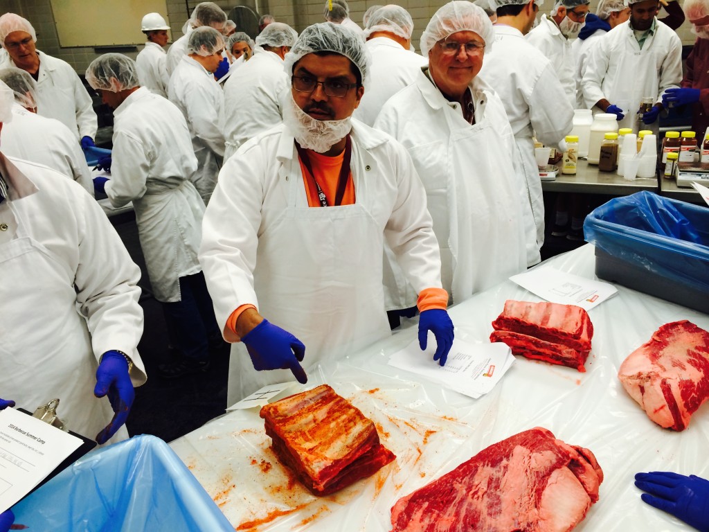 Participants seasoning beef ribs and briskets