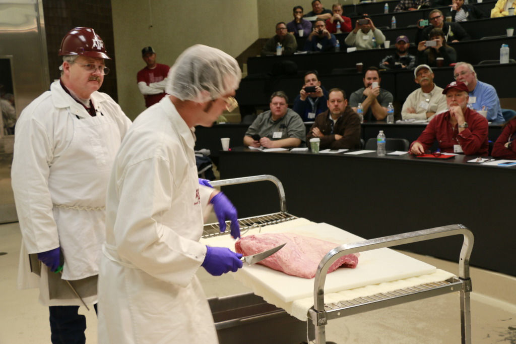 Aaron Franklin demonstrating brisket trimming at Camp Brisket