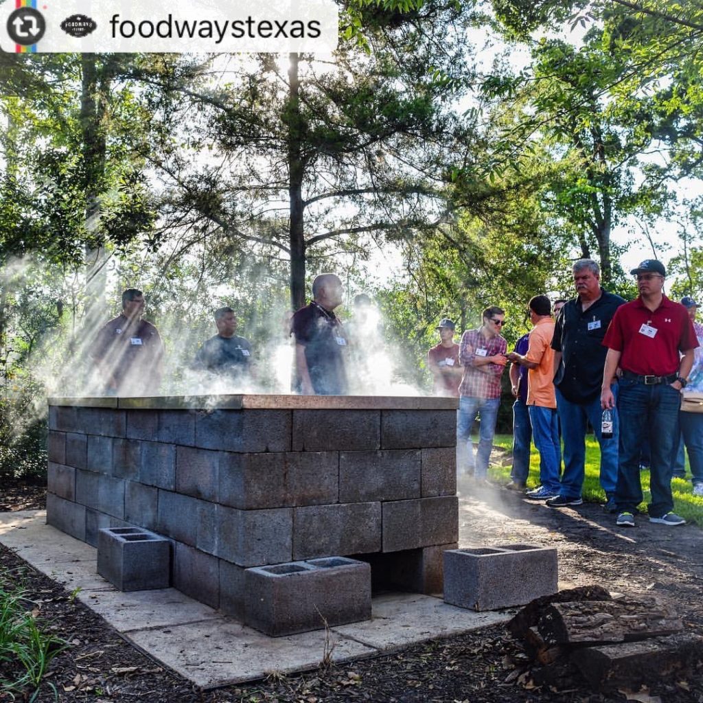 Cinder-block pit fired up and smoking