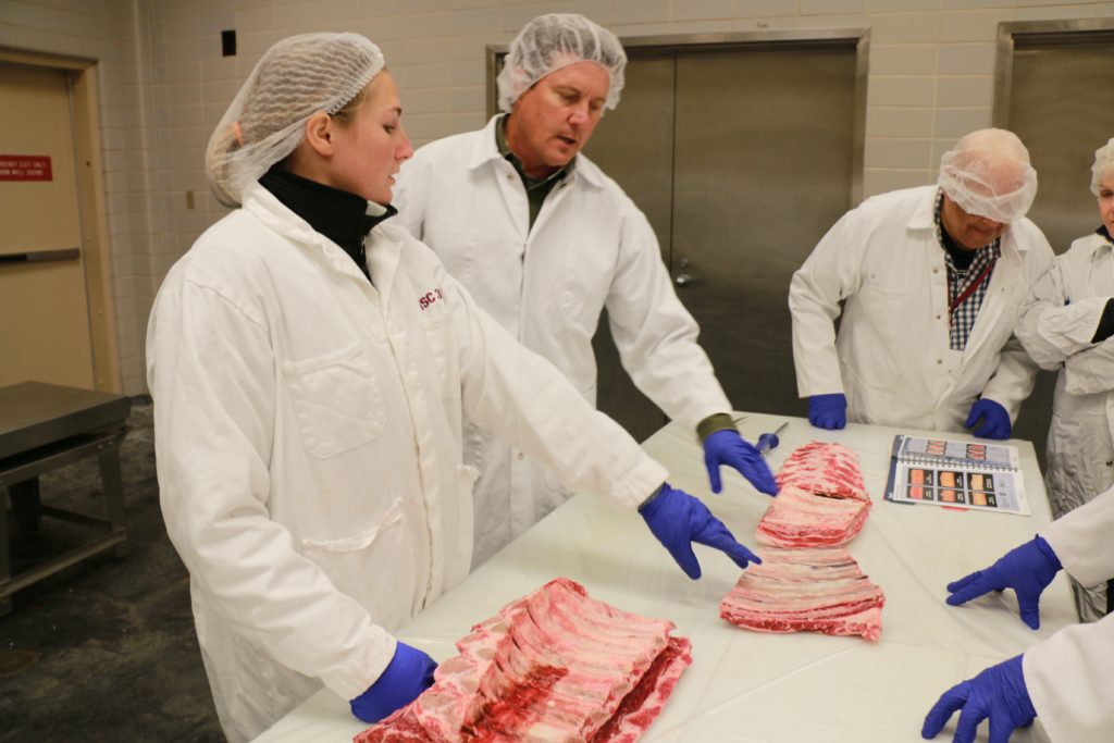 McKensie Harris showing beef rib cuts