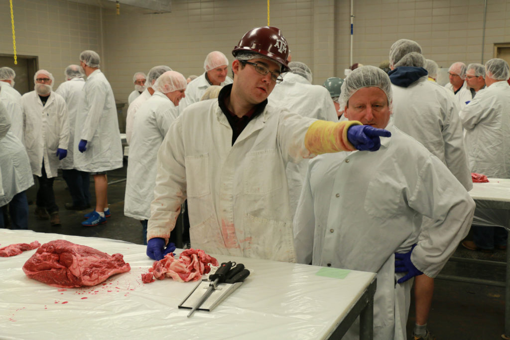 Drew Cassens pointing out beef cut location on carcass