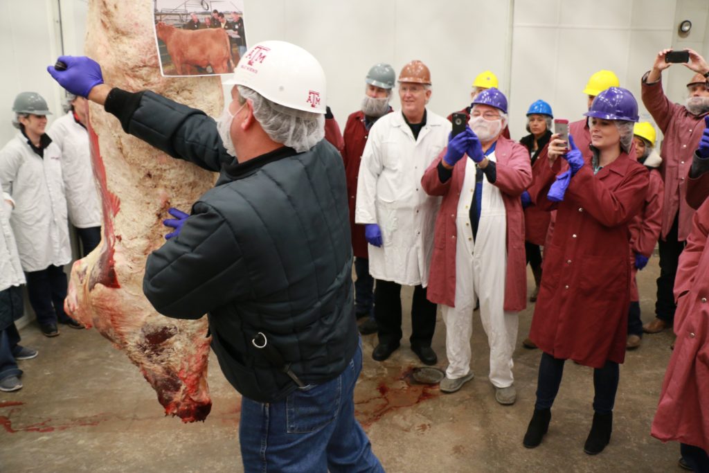 Ray Riley ribbing a beef carcass at the Texas Barbecue Town Hall meeting