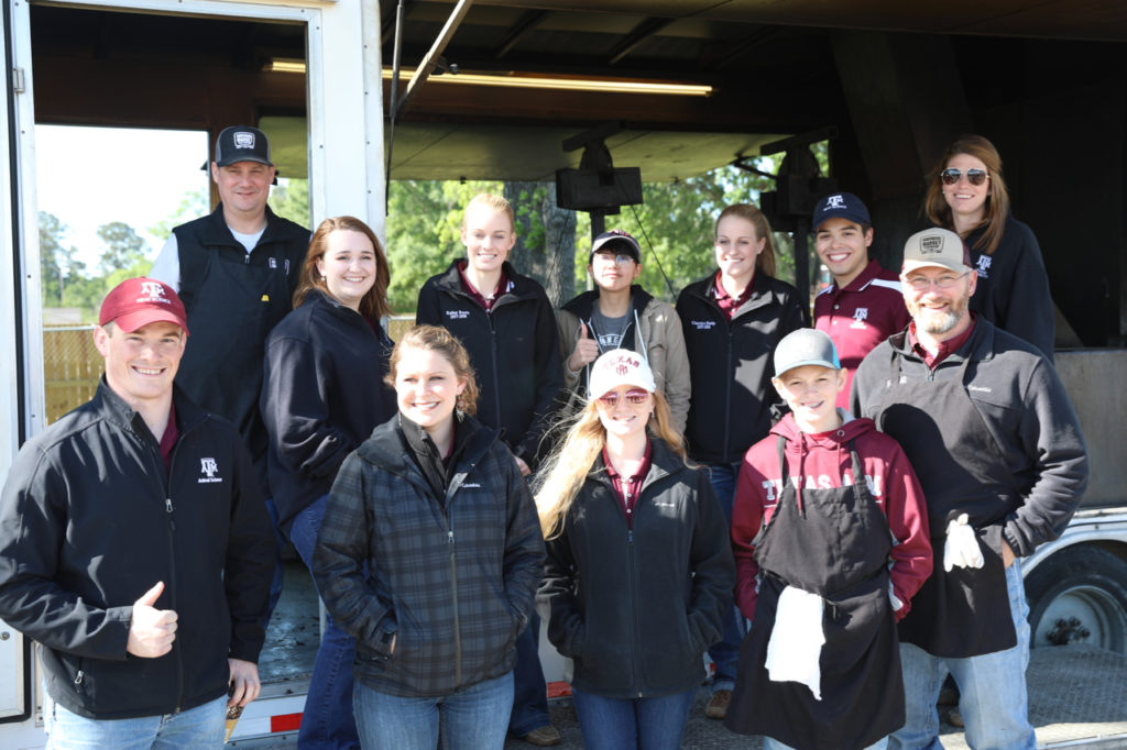 Aggie students visiting with Southside Market and Barbeque folks at the Houston BBQ Festival