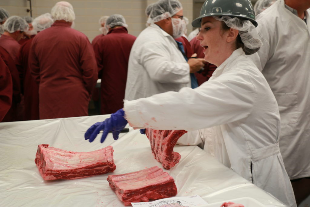 Clay Eastwood demonstrating different beef rib cuts at Barbecue Summer Camp