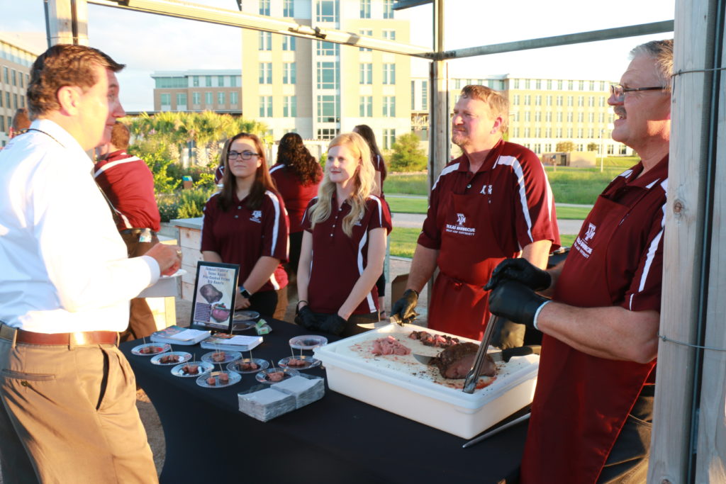 Chandler, Morgan, Ray, and Davey serving samples of Texas Aggie Prime Rib