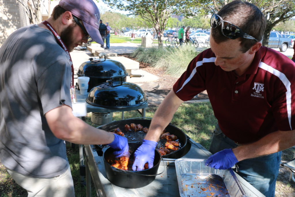 Ty and Eric putting the wings into the Orange Marmalade Sriracha Sauce