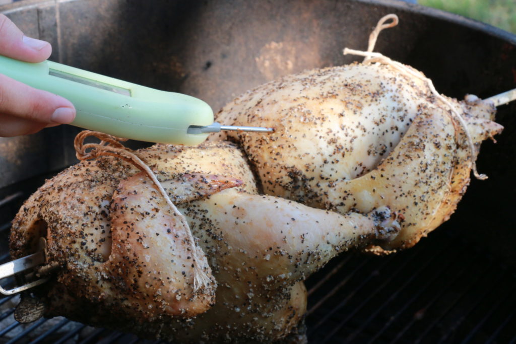 Checking the temperature of the rotisserie chickens