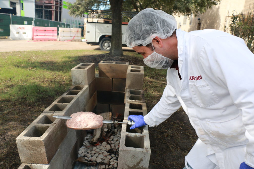 Flavio placing the hump on the grill