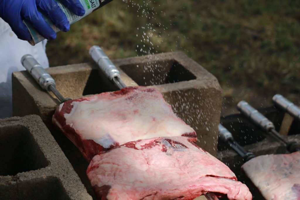 Applying the coarse sea salt to the beef chuck short ribs