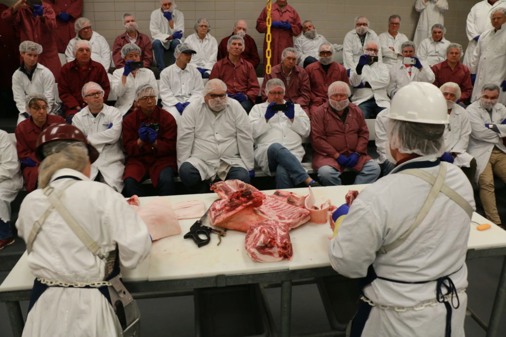 Brogan Horton and Trent Schwartz cutting pork side