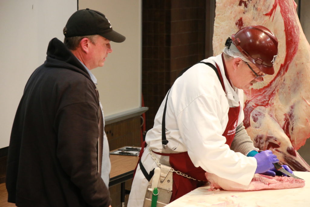 John Brotherton and Davey Griffin demonstrating brisket trimming at Camp Brisket